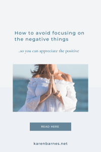 Women with her hands in pray position being thankful that she is not focusing on the negative things.